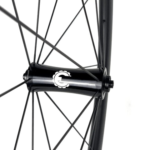 Close-up of 700C Road Bike Carbon Wheelset With 40mm UD X Weave Aero Rims And Rim Brake Surface hub and spokes