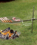 Go To Campfire Grill For Outdoors Lovers, Premium Stainless Steel Portable Cooking Gear For Camping And Backyard Grilling, 24 Inch Cooking Surface shown installed over fire with adjustable stake
