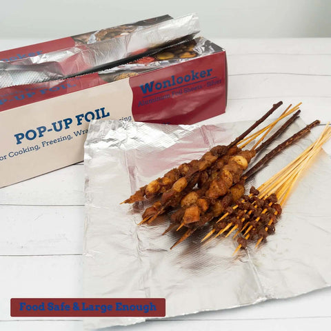 Heavy Duty Aluminum Foil Sheets 500 Pop Up Interfolded 12 By 12 Inch Sheets displayed with grilled skewers