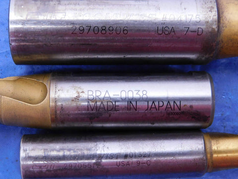 Close-up of three metal drill bits with inscriptions, showing part of a Three Piece Pro Grade Carbide Tipped Spiral Flute Drill Bit Set.