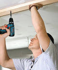 Man using 12V Max Lithium Ion Battery 2Ah Pack Two Battery Pack For Power Tools to install wood beam at ceiling