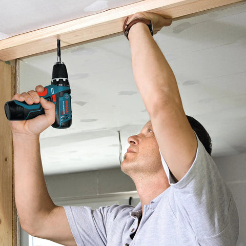 Man using 12V Max Lithium Ion Battery 2Ah Pack Two Battery Pack For Power Tools to install wood beam at ceiling