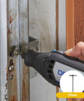 Dremel rotary tool with grinding bit used on a rusted metal door frame