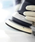Close-up of Multi-Jetstream Dust-Free Random Orbital Finish Sander in use on a smooth surface for wood finishing.