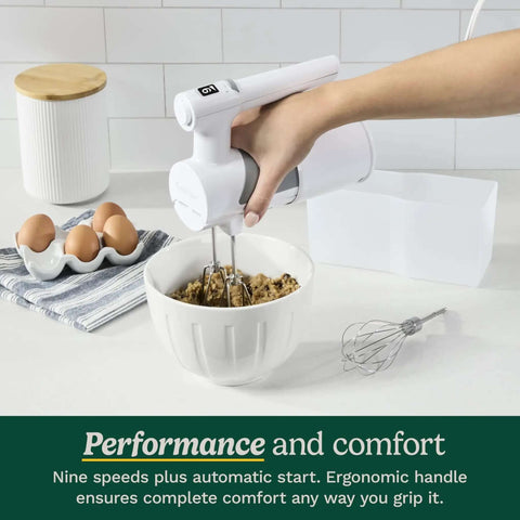 Lightweight Nine Speed Electric Hand Mixer With Grippy Ergonomic Handle And One Touch Digital Controls in use mixing cookie dough.