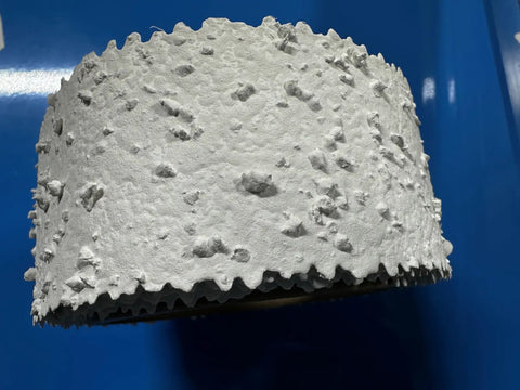 Close-up of Self-Adhesive Pre-Textured Popcorn Ceiling Patch Roll, Paint Ready, 2 In By 5 Ft, Heavy Popcorn Finish on blue background.