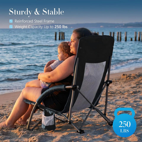 Person sitting on Low Profile Camping Beach Chair With Cup Holder, Storage Pocket, Breeze Mesh Back, on sandy beach