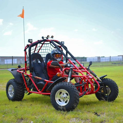 Red go kart with 169cc 10 HP engine, 35 MPH top speed, adult size, independent suspension, and Baja lights on grass field.