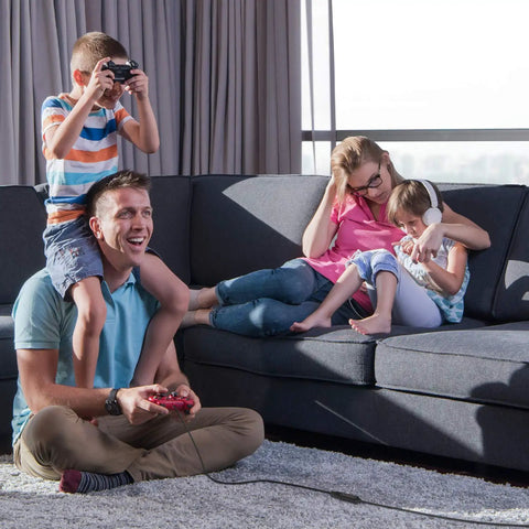 Family playing video games on couch using 32 Foot USB 3.0 Active Extension Cable with 5V 2A Power Adapter and signal booster chips
