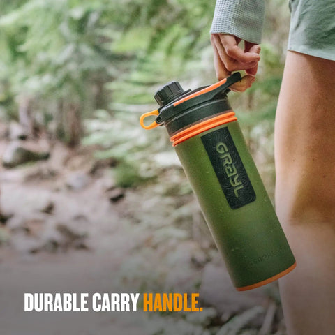 Person holding GeoPress 24 Oz Water Purifier Bottle For Hiking Camping Survival And Travel With Easy Fill Press To Drink Filter