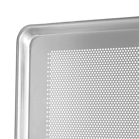 Close-up of the corner of a perforated aluminum sheet pan, showcasing reinforced edge and perforations for airflow.