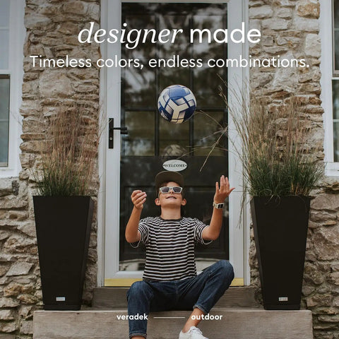 Outdoor setting with a boy playing soccer between two 30-inch black plastic resin taper planters on either side of a stone entrance.
