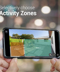 Smartphone displaying activity zones for 2 Pack Outdoor Security Cameras With Auto Spotlight And Color Night Vision. Hands holding phone.