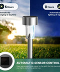Close-up of 16 Pack Solar Lights Outdoor Waterproof Stainless Steel LED Garden Lights illuminating lawn at night