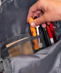 Hand organizing pens and highlighter in mesh pocket of Deer Camo Backpack For School And Everyday Outdoor Adventures 25L Capacity