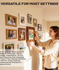 Woman using All In One Picture Hanging Tool That Levels Dead Straight No Sweat to hang a colorful framed artwork on wall.