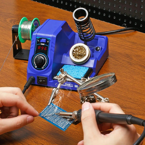 Hands using the Ready To Roll Soldering Station Kit With 130W Max Power And 926LED V3 on a circuit board with tools and accessories.