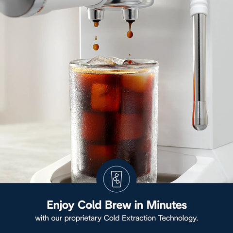 Cold brew pouring into a glass filled with ice from a Compact Espresso And Cold Brew Coffee Maker Featuring Built In Milk Frother Wand For Next Level Iced Lattes Smooth Hot Drinks And Straight Up Barista Quality Blends Daily.