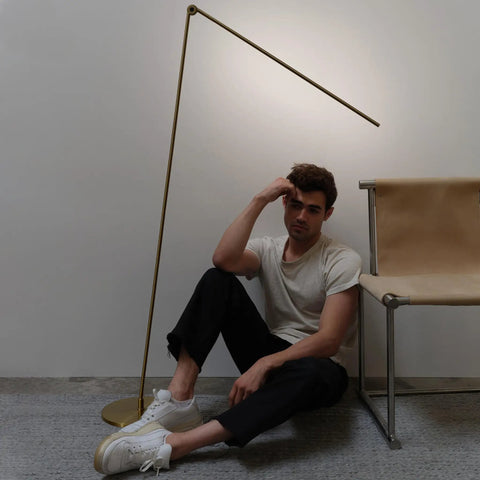 Libra LED Floor Lamp With Adjustable Pivot Arm And Built In Dimmer beside modern chair, brass design for reading