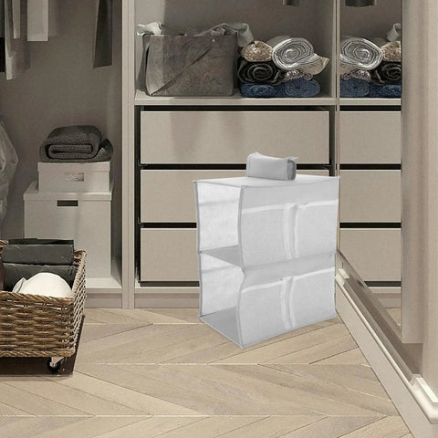 Layered Hanging Storage Bag Slick Nonwoven Closet Organizer With Roomy Pockets Low Key, filled with towels in closet.
