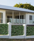 Expandable Fence Privacy Screen With Faux Ivy Fencing Panel surrounding a patio on a home, willow frame visible, outdoor decor