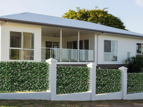 Expandable Fence Privacy Screen With Faux Ivy Fencing Panel surrounding a patio on a home, willow frame visible, outdoor decor