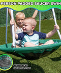 Children playing on the 32in saucer swing of the Northridge Metal Swing Set With Five Seat Swing 500 Lb Capacity 32 Inch Saucer Swing Two Blow Molded Swings And Five Foot Slide Durable Six Foot Frame Backyard Playset For Kids Ages Three To Eight.
