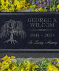 Personalized Granite Memorial Stone For Grave Decor; black granite with engraved tree, 12x8x2 inches, amidst yellow flowers