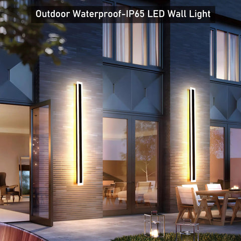 Two Pack 23.6 Inch Outdoor Modern LED Wall Light 18W IP65 Waterproof Black Wall Mount Fixture With Frosted White Acrylic Rectangular Design For A Brightly Lit Porch And Exterior installed on a modern house wall.