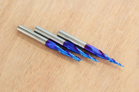 Three Pack Tapered Ball Nose Router Bits One Eighth One Sixteenth One Thirty Second Inch Cutting Diameter One Quarter Inch Shank Sweet Nano Blue Coated Up Cut Solid Carbide CNC Bits For 2D And 3D Carving Two And A Half Inch Overall Length on wood surface