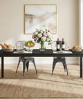 Extra Long Dining Table With Badass Steel Legs, Rectangle Kitchen Table And Dinner Spot Seats The Whole Squad Comfortably, modern black wood top, set for dining with flowers and wine.