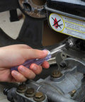 Using a screwdriver on machinery in a vehicle repair, showcasing part of the 39-Piece Drive Socket Set With Quick-Release Ratchet.