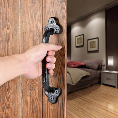 Hand pulling Rustic 9 Inch Cast Iron Sliding Barn Door Handle 2 Pack Black Vintage Gate Pull installed on wooden door