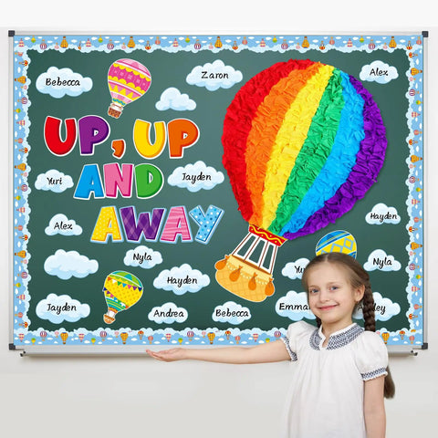 Hot Air Balloon Bulletin Board Set With 57 Pieces Including Balloons And Clouds Borders Letters And Crepe Paper Rolls For Back To School Classrooms Windows Walls And Doors Decor Kid Friendly Fun Preschool Elementary Summer displayed on a classroom wall with a smiling child.