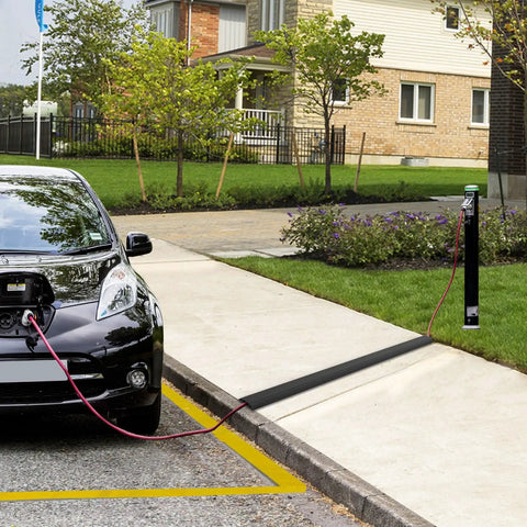 Heavy Duty PVC Floor Cord Cover For Wires And Cables black ramp in use over sidewalk, preventing trip hazards, for home or office safety.