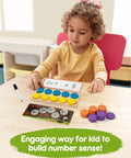 Child using Wooden Ten Frame Math Set With 152 Pieces For Kindergarten And Elementary Students Kid Friendly Ideal For Addition Subtraction Practice Montessori Style Counters Dice Number Stones Dry Erase Boards And Game Cards For Homeschooling at desk