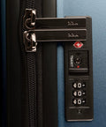 Close-up of TSA lock on 26 inch polycarbonate spinner luggage in matte navy.