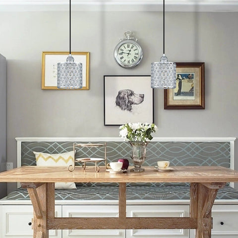 Dining room with two three pack polyhedral crystal pendant lights with nickel finish, sleek modern vibe crystal shade.