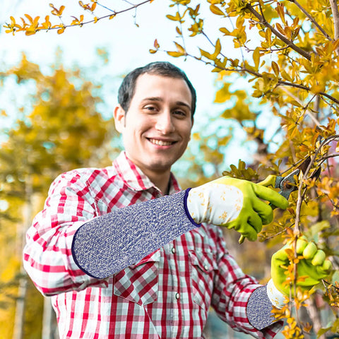 Man wearing Five Pack Cut Resistant Arm Sleeves For Men And Women, Level Five Bite Proof Forearm Guards while pruning trees