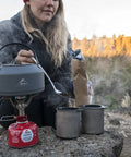 Person using Alpine Long Camping Spoon With Jet And Cable Tool For Stoves Stainless Steel Build to stir pot on portable stove