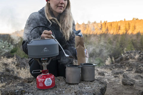 Person using Alpine Long Camping Spoon With Jet And Cable Tool For Stoves Stainless Steel Build to stir pot on portable stove