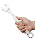 A hand holding Heavy Duty One And One Sixteenth Inch 12 Point Combination Wrench With No Slip Grip For High Torque In Industrial Chrome Vanadium Steel Spanner 15 Degree Offset Sand Blasted Finish Heat Treated Forged Tool.