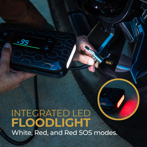 Portable Car Jump Starter With 600 Amp Peak, 130 Psi Tire Inflation in use, displaying LED floodlight feature on tire.