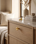 Top Shelf Unlacquered Brass Cabinet Knobs Straight Up Modern Round Dish Hardware Featuring Live Patina Finish 1.18 Inch Face Width For A Cool Kitchen Revamp Two Pack Bundle on a wooden drawer.