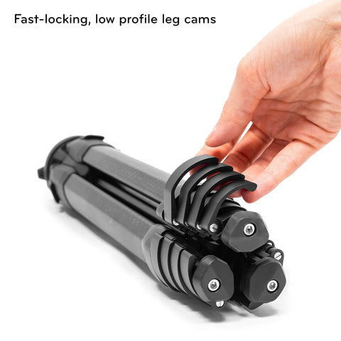 Hand holding folded Carbon Fiber Travel Tripod With Pro Level Stability, Fast Setup And Takedown, Ergonomic Ball Head, Ultra Compact And Portable.