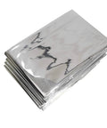 Stack of folded emergency blankets included in 10 In 1 Emergency Survival Kit With Knife, Blanket, Compass, Fire Starter, Flashlight, Saw, And More