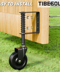 Real Deal Four Inch Spring Loaded Gate Wheel For Outside Wood Fences With Anti Sag Support Roller And Easy Roll Three Sixty Spin Built Tough To Hold Two Hundred Twenty Pounds Stress Free In Matte Black One Piece mounted on a wooden fence.
