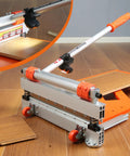 Heavy Duty 13 Inch Vinyl Floor Cutter With Wheels Built Tough For No Sweat Trimming Of LVP LVT VCT SPC WPC Engineered Wood Laminate Cutting Led Light HSS Blade Hella Smooth Cuts On Flooring Jobs, showcasing blade and handle details.