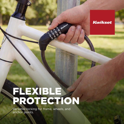 Person securing bike with 4 Digit Combination Bicycle Cable Lock, 5/16 Inch Diameter Security Cable For Bikes, Scooters, Electric Bikes, And Strollers, Keyless Outdoor Protection, Heavy Duty Weatherproof Design.
