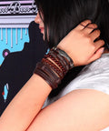 Dope Vintage Punk Wrap Bracelet Set Of Six Braided Faux Leather Cuffs For Men And Women worn on wrist with a background.